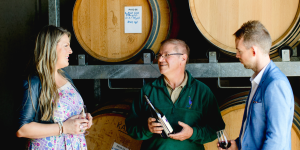 Rick with visitors talking about wine